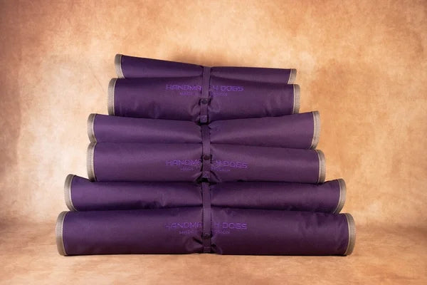 pflaume farbenes gerolltes Hunde Reisebett handgefertigt von handmade 4 dogs mit einer mintgrünen dicken Liegefläche aus Microfaser