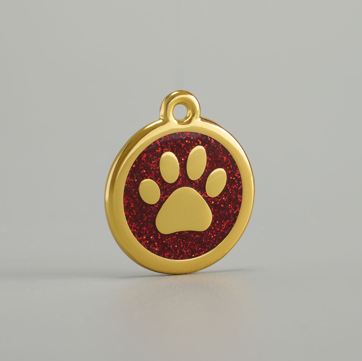Goldene Hundemarke mit erhabener Pfote und roter Glitzer-Epoxidharz-Hintergrund