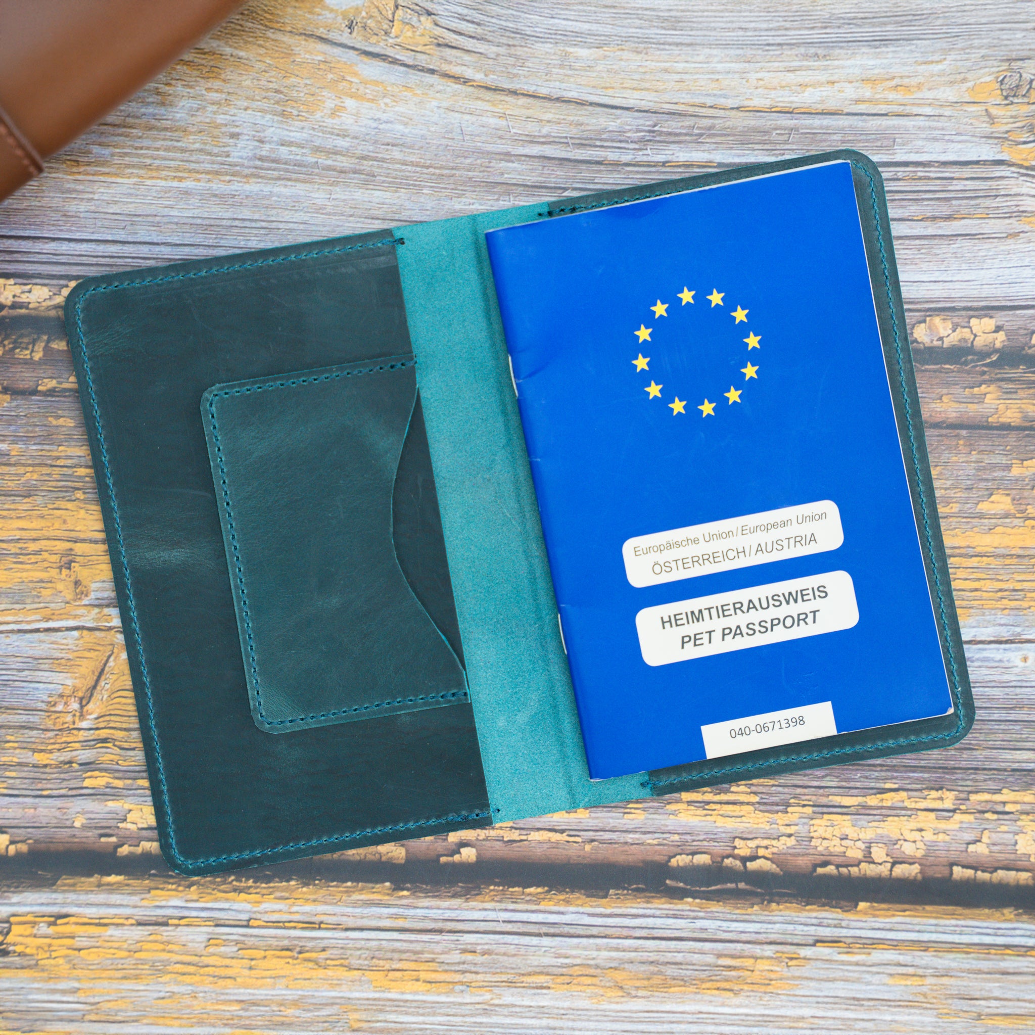 geöffnete-crazy-horse-leder-impfpasshülle-für-haustiere-mit-pfotengravur-in-petrol