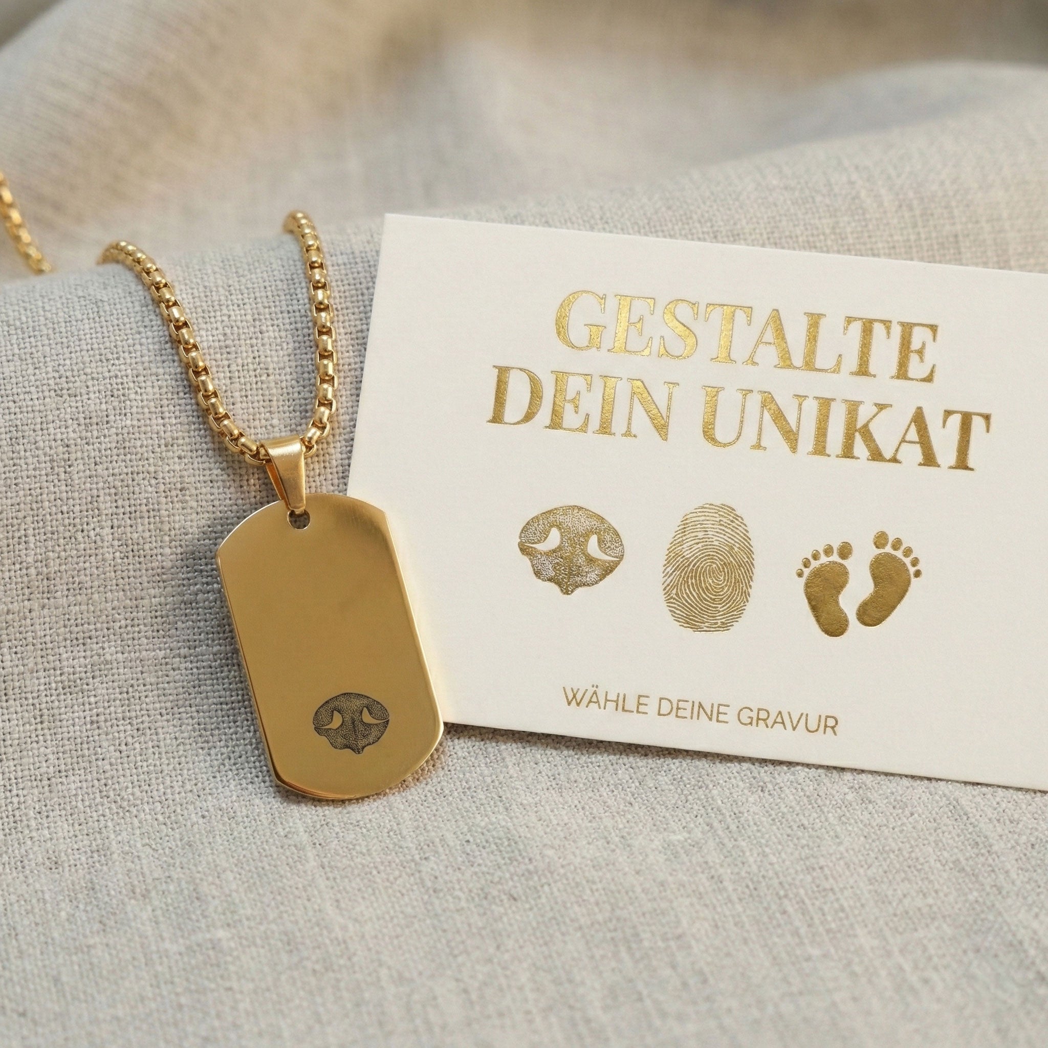 Goldenes Mini Dog Tag mit Nasenabdruck-Gravur auf Leinenstoff