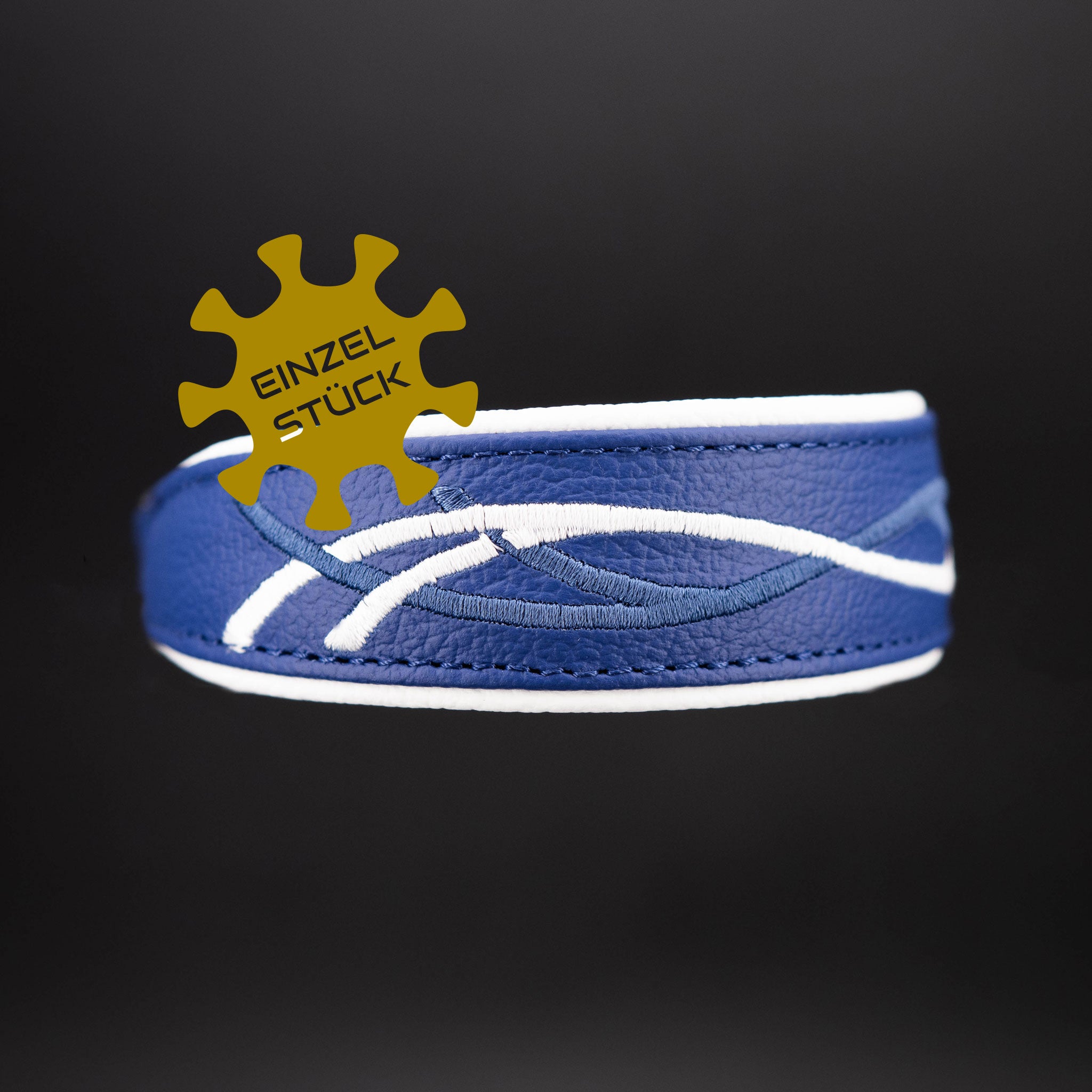 Detailaufnahme der Stickerei auf dem aralblauen Rindsnappaleder Einzelstueck